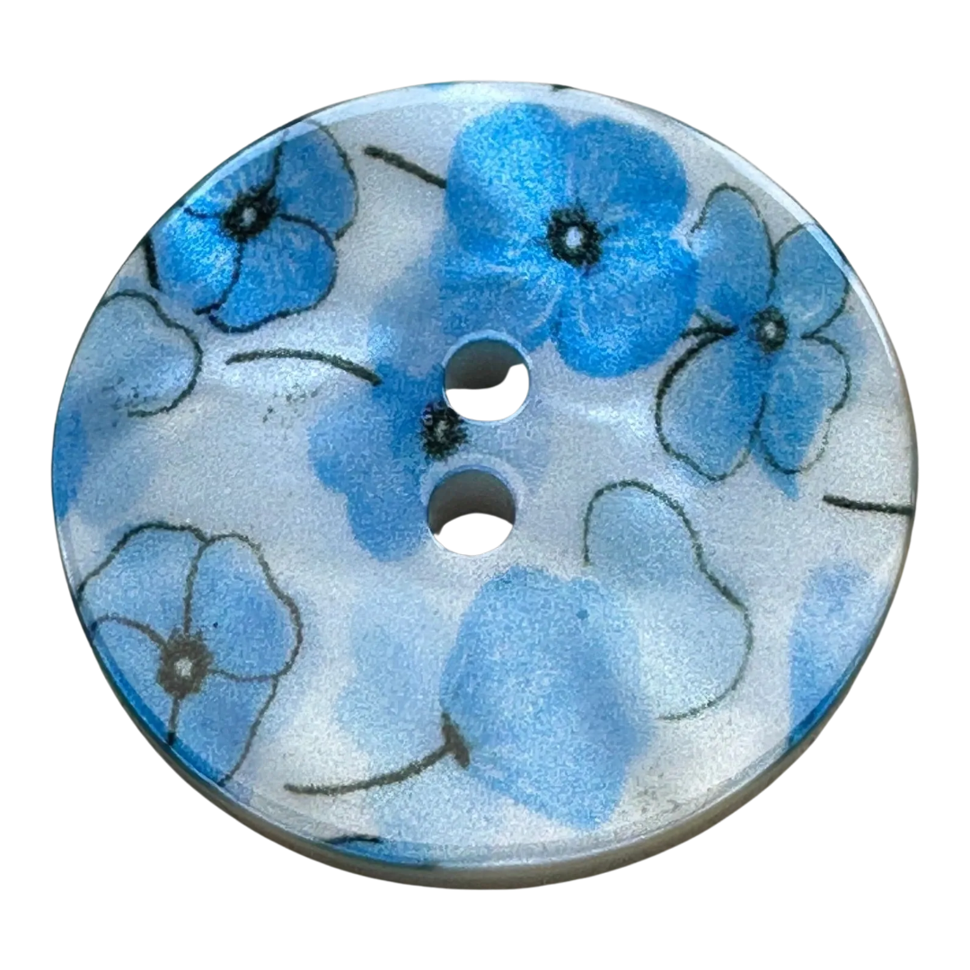 Blue flower button 23mm pearlised on a white background sold individually